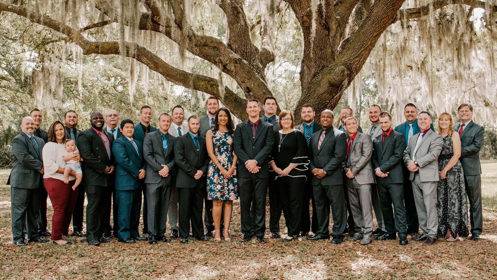 Loving Hands staff and residents posed together under an oak tree.